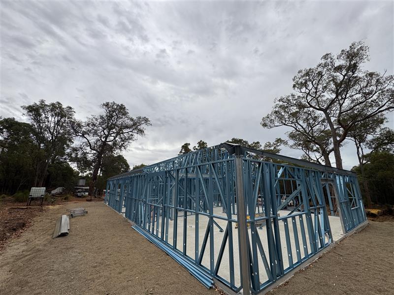 Long steel frame run on a rural block under an overcast sky